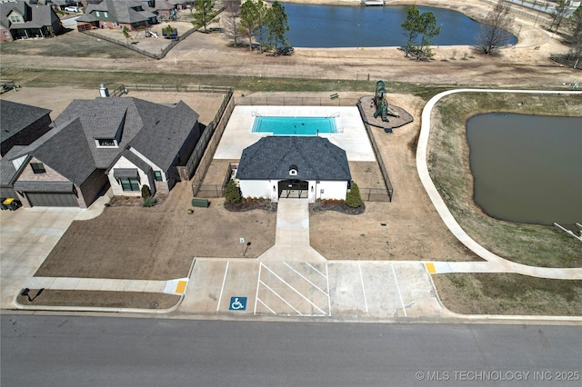 birds eye view of property with a water view