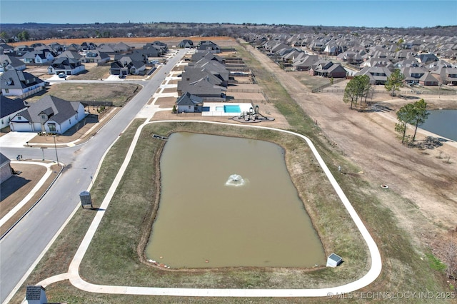 drone / aerial view with a water view and a residential view