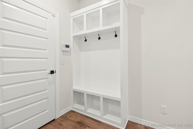 mudroom featuring baseboards and dark wood-style floors