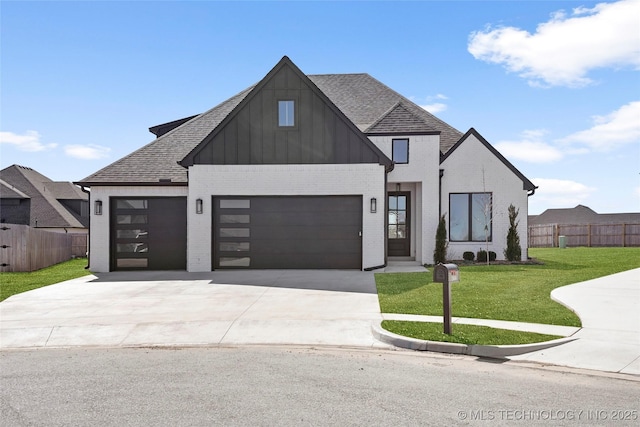 view of front of house featuring concrete driveway, brick siding, fence, and a front lawn