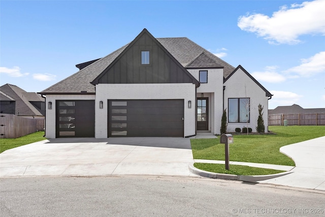 modern farmhouse with driveway, an attached garage, a front lawn, brick siding, and fence