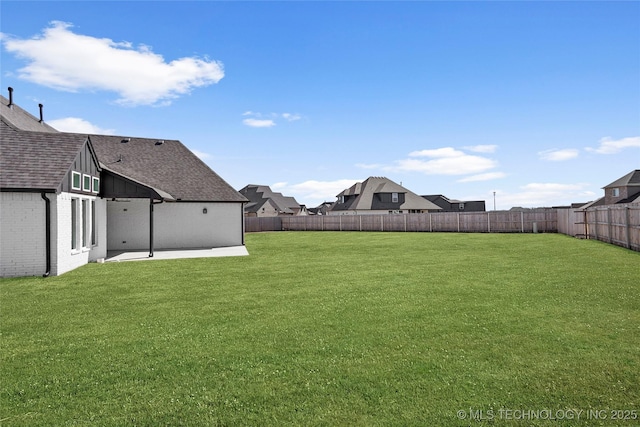 view of yard featuring a patio and a fenced backyard
