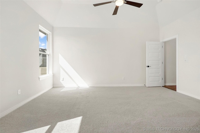 carpeted empty room with high vaulted ceiling, ceiling fan, and baseboards