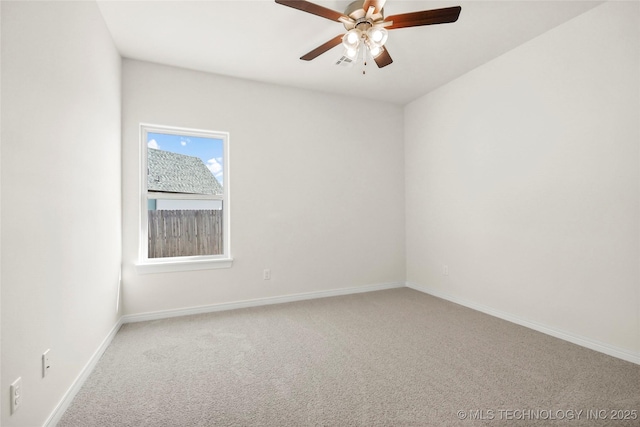 unfurnished room with visible vents, baseboards, a ceiling fan, and carpet