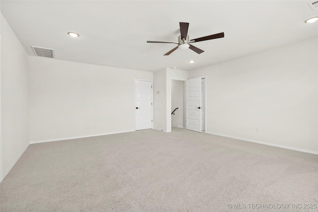 empty room with recessed lighting, visible vents, light colored carpet, and a ceiling fan