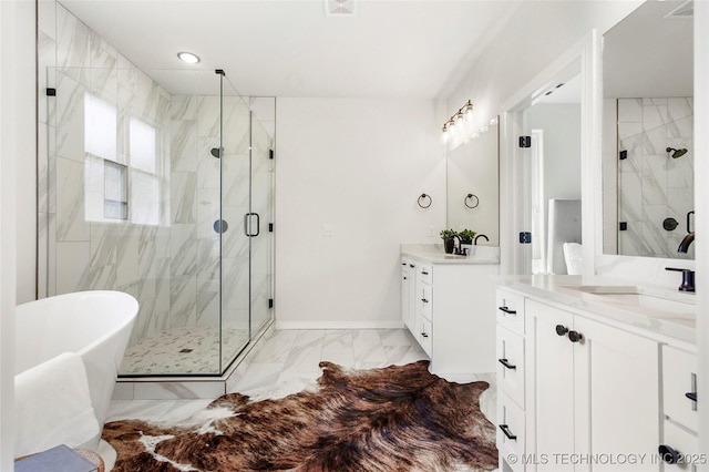 full bath featuring a stall shower, two vanities, marble finish floor, and a sink