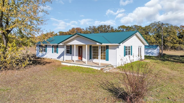 ranch-style home with covered porch and a front yard