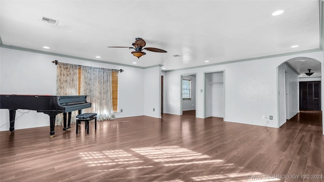 interior space featuring ceiling fan, crown molding, and hardwood / wood-style flooring