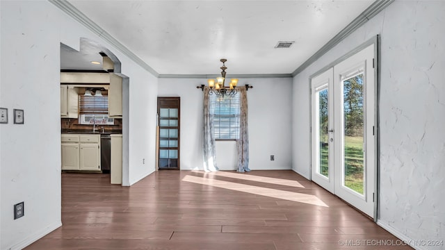 unfurnished dining area with ornamental molding, an inviting chandelier, and dark wood-type flooring