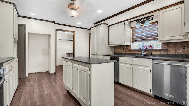 kitchen featuring appliances with stainless steel finishes, backsplash, a center island, dark hardwood / wood-style floors, and white cabinetry