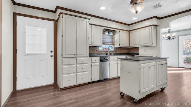 kitchen with crown molding, white cabinets, wood-type flooring, and a kitchen island