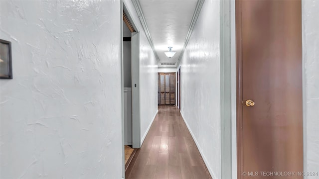 corridor with hardwood / wood-style floors