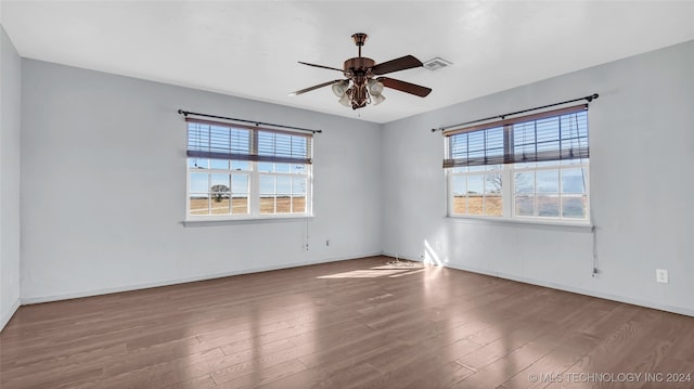 unfurnished room with hardwood / wood-style floors, plenty of natural light, and ceiling fan