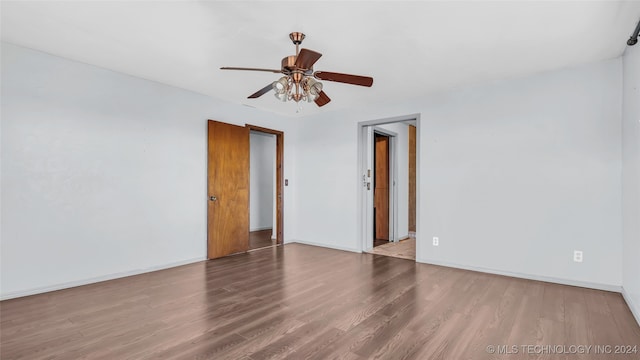 unfurnished room with hardwood / wood-style flooring and ceiling fan