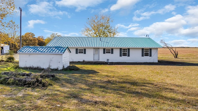 back of house with a lawn