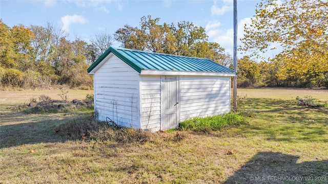 view of outbuilding with a lawn