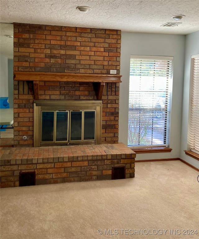 room details featuring a fireplace, a textured ceiling, and carpet flooring