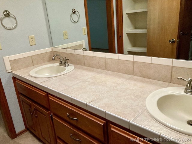 bathroom featuring decorative backsplash, built in features, and vanity