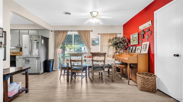 dining space featuring ceiling fan and light wood-type flooring