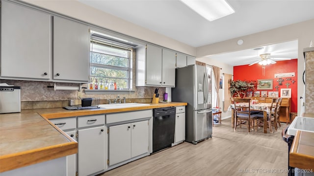 kitchen with ceiling fan, dishwasher, sink, stainless steel refrigerator with ice dispenser, and light hardwood / wood-style floors