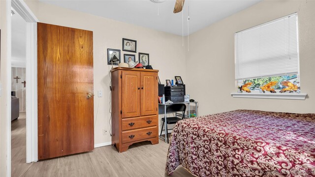 bedroom with ceiling fan and light wood-type flooring