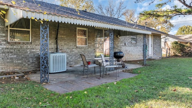 back of property with a lawn, a patio area, and central air condition unit