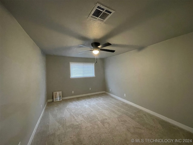 unfurnished room featuring light carpet and ceiling fan