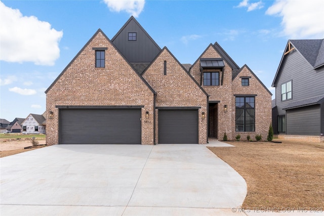 5812 E 127th St S, Tulsa, OK 74008 - view of front of property with board and batten siding, driveway, brick siding, and an attached garage