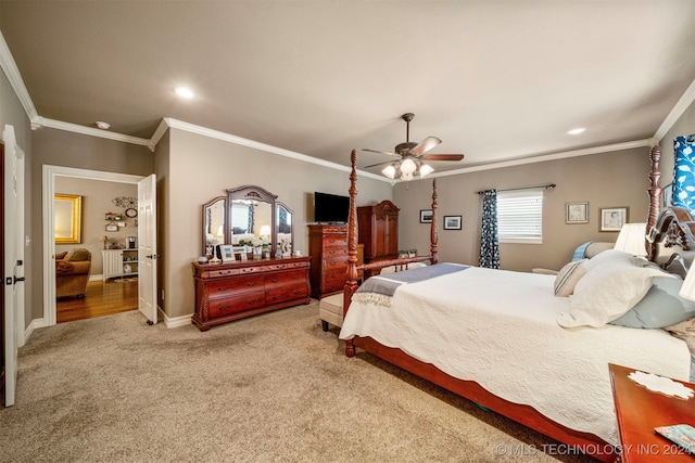 carpeted bedroom with ornamental molding and ceiling fan