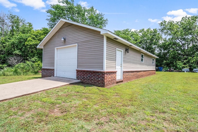 exterior space with a garage and a lawn