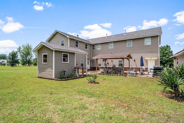 rear view of property featuring a yard, a patio, and a gazebo