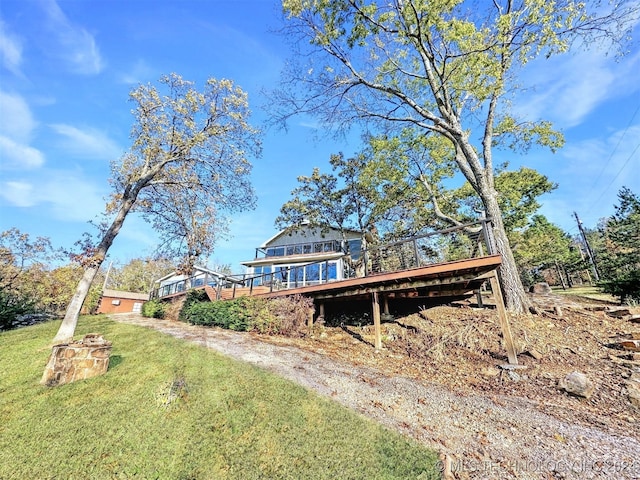 view of front of property with a front yard and a wooden deck