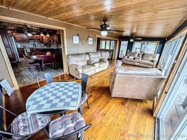 living room featuring ceiling fan, light hardwood / wood-style flooring, wood ceiling, and vaulted ceiling