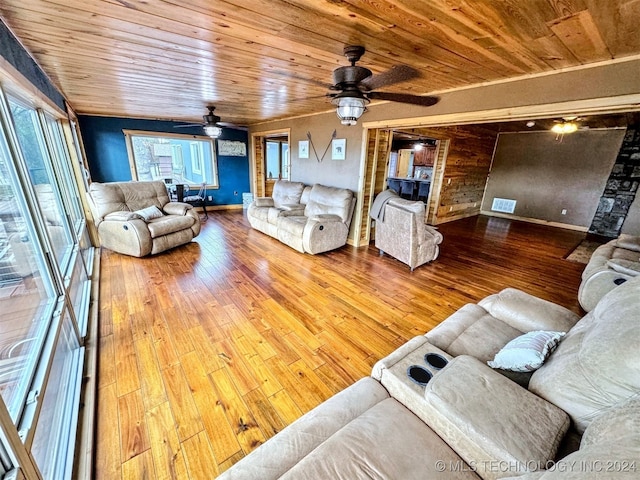 living room featuring wood-type flooring, ceiling fan, and wooden ceiling