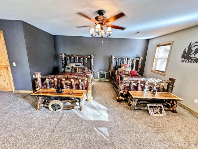 carpeted bedroom featuring a textured ceiling and ceiling fan