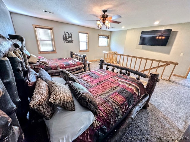 bedroom with carpet flooring, ceiling fan, and a textured ceiling