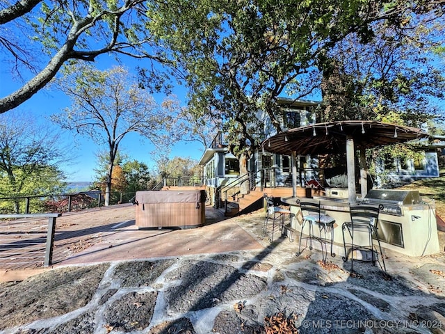 exterior space with an outdoor kitchen, exterior bar, and grilling area