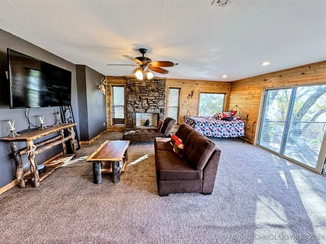 bedroom with a fireplace, access to exterior, carpet floors, and ceiling fan