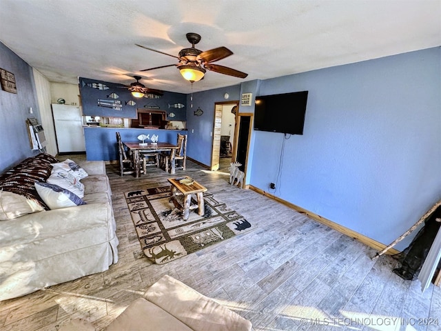 living room with hardwood / wood-style flooring and ceiling fan