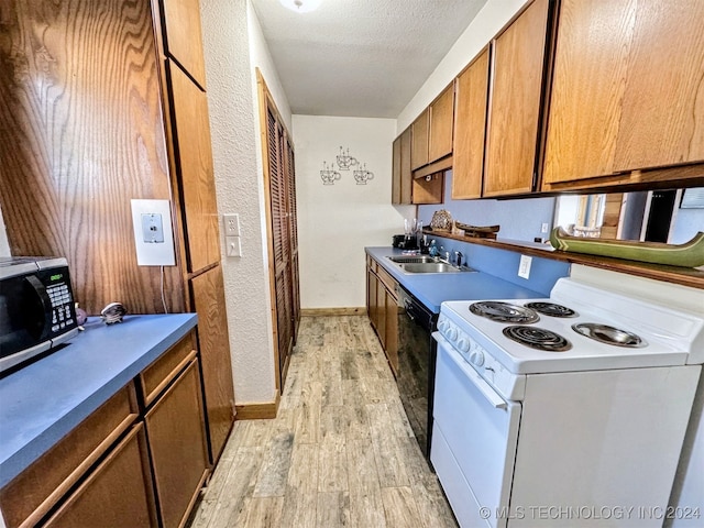 kitchen with dishwasher, sink, light hardwood / wood-style flooring, a textured ceiling, and electric stove