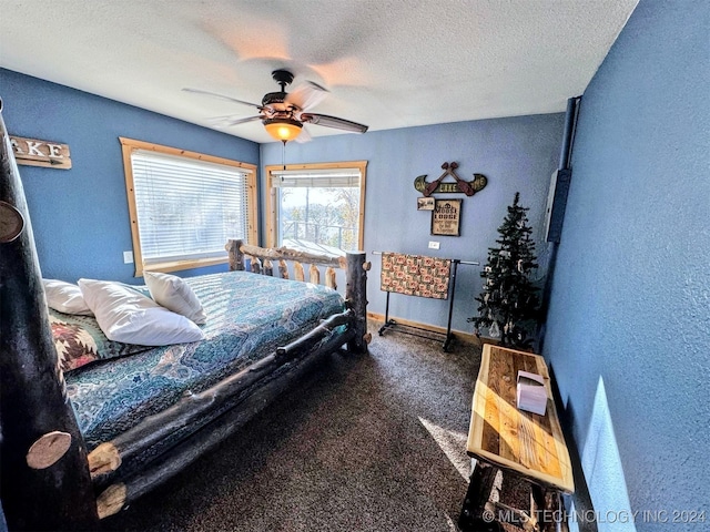 carpeted bedroom with a textured ceiling and ceiling fan