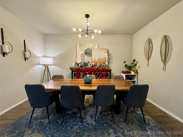 dining space featuring dark hardwood / wood-style floors and an inviting chandelier