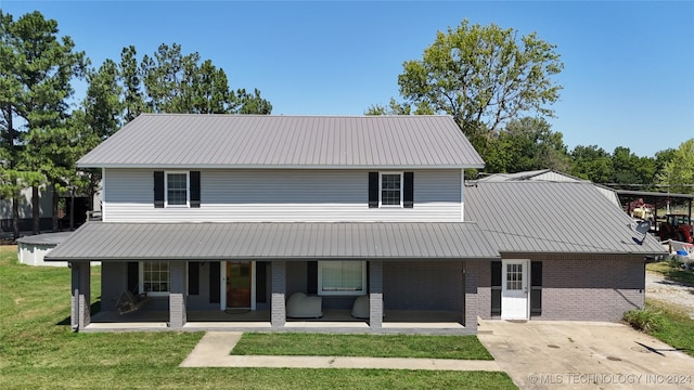 view of front of house with a porch and a front yard