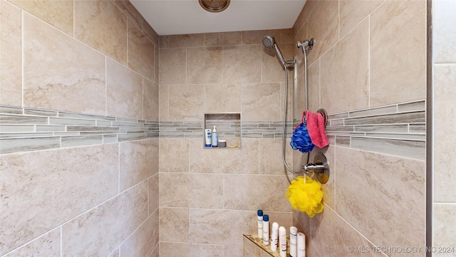 bathroom with a tile shower