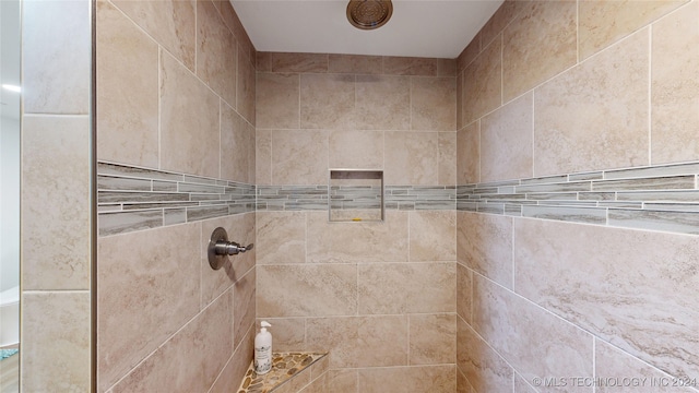 bathroom with a tile shower