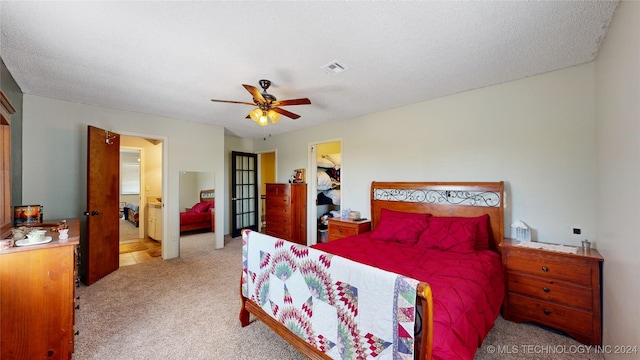 carpeted bedroom featuring a textured ceiling, a closet, a spacious closet, and ceiling fan