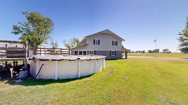 view of yard featuring a rural view and a covered pool