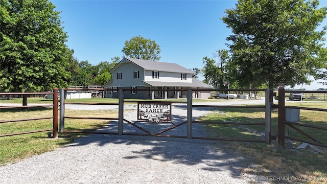 view of gate with a lawn