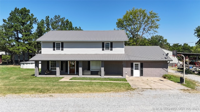 view of front of property featuring a front lawn and covered porch