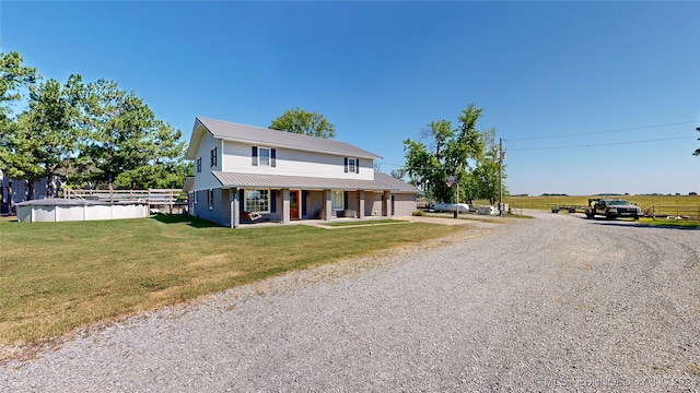 view of front of house featuring covered porch and a front lawn